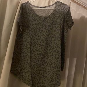 Two leopard print shirts.. one is baby blue with leopard pocket other leopard